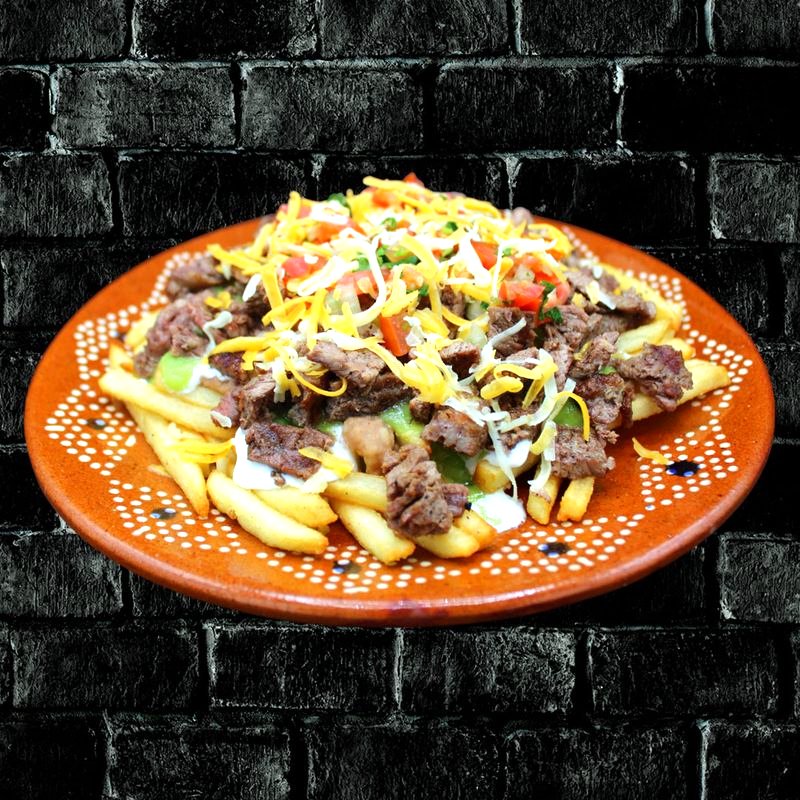 Rivas asada loaded fries piled with grilled steak, cheese and guacamole